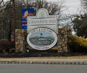 Creekside Inn sign by the road